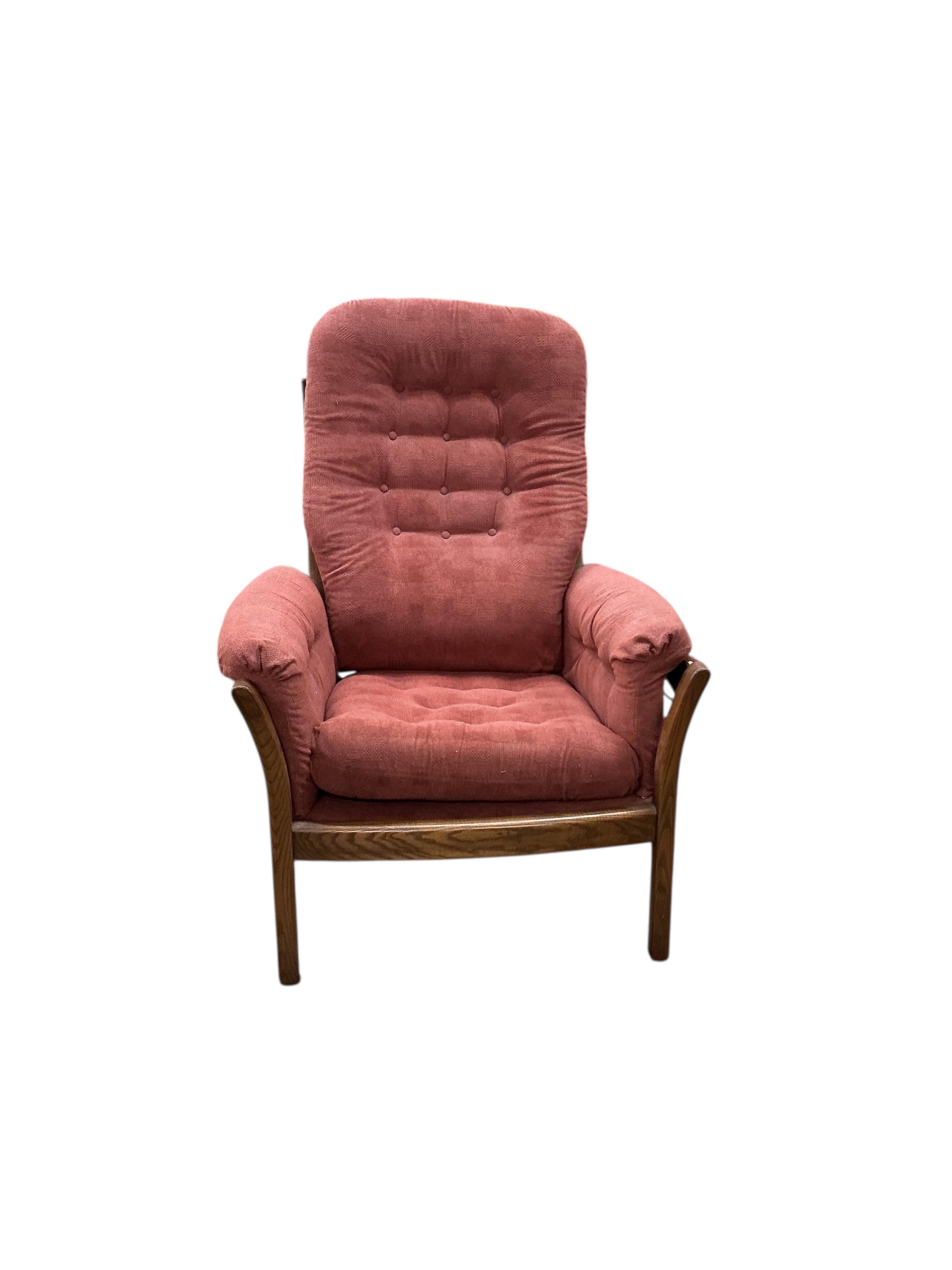 An Ercol elm three piece suite, settee width 130cm, depth 68cm, height 104cm